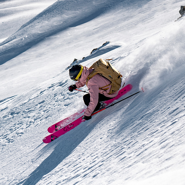 Woman skiing on pink Fischer Ranger all-mountain skis