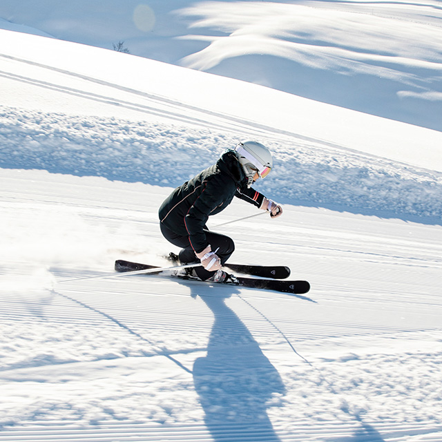 woman skiing a groomer trail on rossignol carving skis