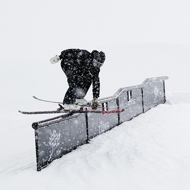 man skiing a rail in the terrain park on Line brand skis