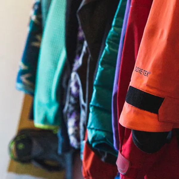 coat rack with red and green jackets hung up