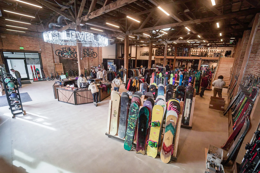 Industrial building with retail fixtures holding assortments of clothing and ski products.