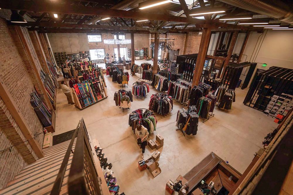 View of a sales floor from the top of the stairs. It is an industrial building with concrete floors.