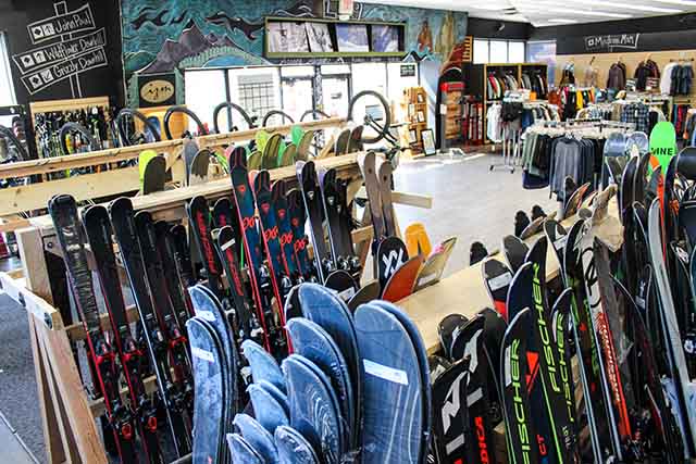 Ski Racks holding skis for sale as well as the entrance to our Ogden Retail store.
