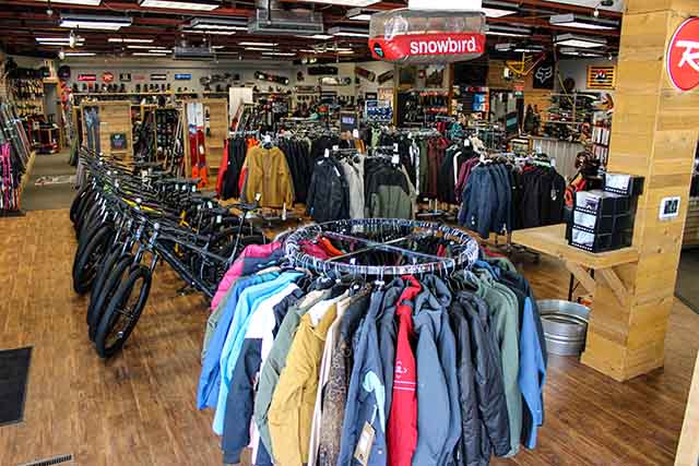 A mixture of Bikes, Skis, and Apparel viewed from the entrance of Level Nine Orem
